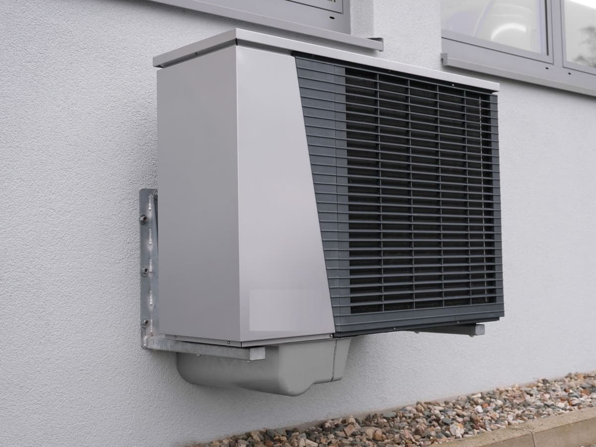Air-to-water heat pump outside a West Coast home in the rain